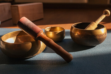 Authentic tibetan singing bowls for meditation and relaxation on yoga mat. Sound massage and healng.