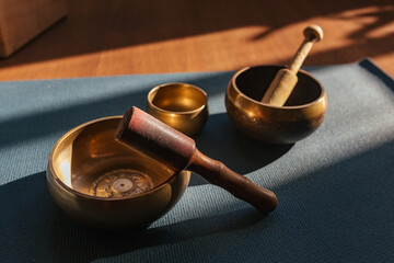 Authentic tibetan singing bowls for meditation and relaxation on yoga mat. Sound massage and healng.