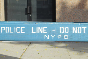 Police line, do not cross, NYPD blue wooden barricade on closed street in New York City