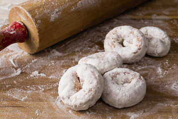 Powdered doughnuts or donuts and roller pin
