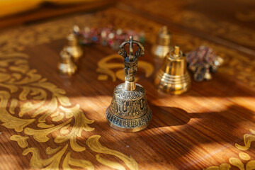 Fototapeta na wymiar Tibetan bells, for meditation and relaxation on wooden table. Sound massage and healng.