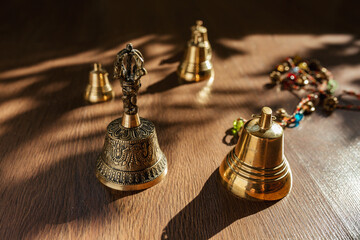 Fototapeta na wymiar Tibetan bells, for meditation and relaxation on wooden floor. Sound massage and healng.