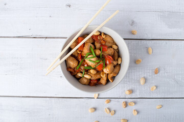 Rice with spicy kung pao chicken on a plate.
