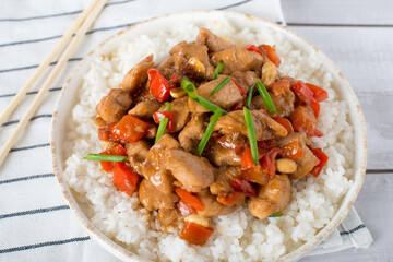 Kung Pao Chicken in white plate on Wood Background