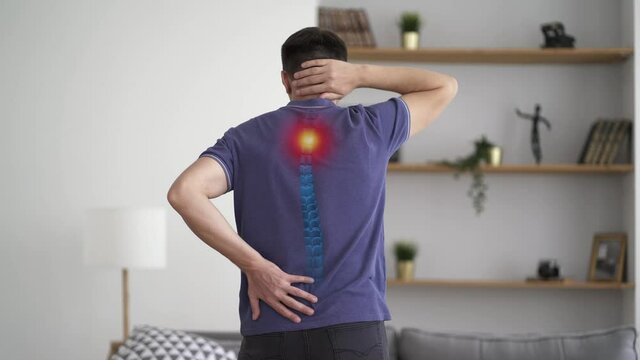 Intervertebral hernia, neck and lumbar pain, man suffering from backache at home, spinal disc disease, health problems concept