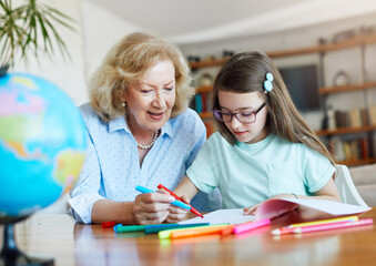 homework teaching education grandmother children granddaughter familiy childhood child teacher classroom senior color coloring painting book notebook