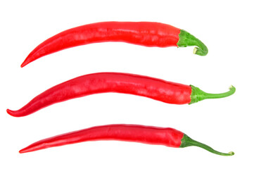Three pods of red hot chili peppers, arranged in a row on a horizontal surface