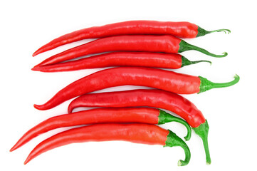 Pods of red hot chili peppers, laid out in a row on a horizontal surface