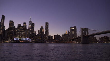 Naklejka na ściany i meble Brooklyn Bridge and Manhattan skyline at night, New York City