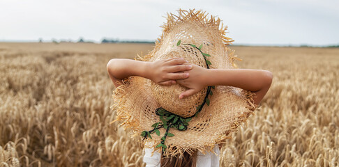 A child in a wheat field. Selective focus.