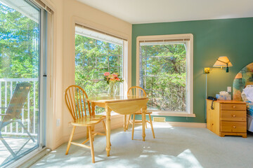 Table with flowers and two chairs. Interior design of a luxury living room.