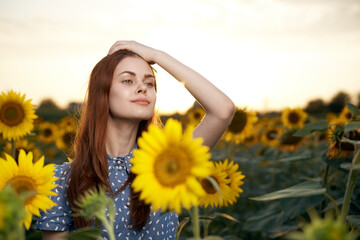 Fototapeta na wymiar pretty woman with hat in the field of sunflowers freedom nature