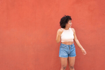 Afro American Woman Standing On Ivy Wall.