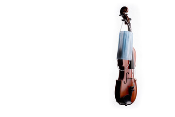 A brown violin or viola from wood on a white background with a medical mask hanging off of one of its pegs No.7