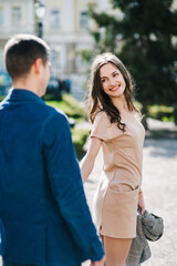 Fototapeta premium guy and a girl happily walk in the morning on the empty streets