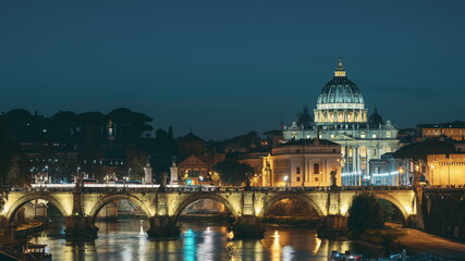 Fototapeta premium Vatican, Italy. Papal Basilica Of St. Peter In The Vatican And Aelian Bridge In Evening Night Illuminations. Day To NIght Time Lapse. Sunset Time