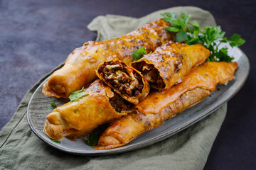 Traditional Turkish crispy sigara borek rolls with minced meat rolled in fillo pastry served as...