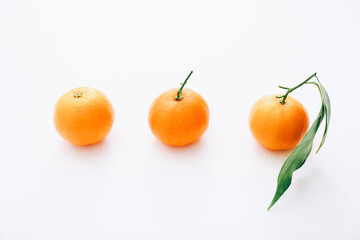 Fresh clementines in row on white background