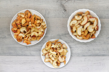 three plates with dry red apples