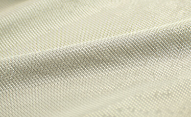 texture. close-up of shiny gold fabric. gold jersey. shiny jersey