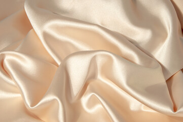 Silk background. Silk beige. Suit fabric. Artistic sheen fabric