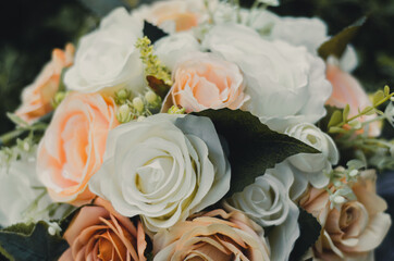 wedding bouquet of white and peach colored flowers