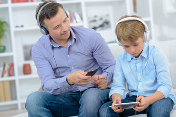 Father and son wearing headphones