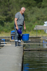 senior man working at a fish farm