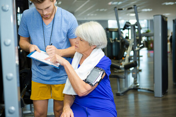 fitness instructor talking to senior woman