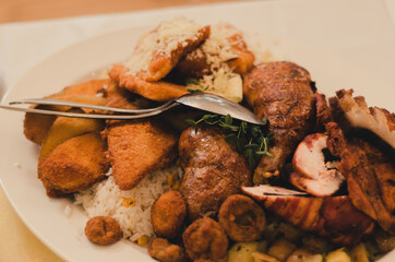 Fried and grilled meat with vegetables and cheese