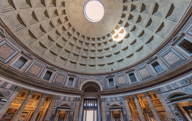 Fototapeta na wymiar The Pantheon, a building completed by the emperor Hadrian in 126 AD. It is circular with a portico of large granite Corinthian columns; its dome is the world's largest unreinforced concrete dome. Rome
