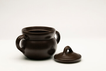 Brown ceramic pot on white background