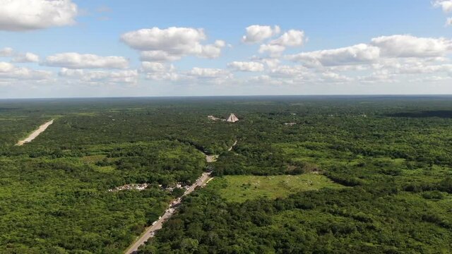 4K Aerial View of Chichen Itza, Temples Complex of Ancient hidden Mayan City in Mexican Rainforest, Drone Shot. Famous Kukulkan Pyramid in the middle of nature. Yucatan, Mexico. Pyramid El Castillo.