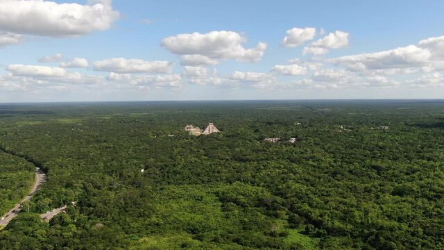 4K Aerial View of Chichen Itza, Temples Complex of Ancient hidden Mayan City in Mexican Rainforest, Drone Shot. Famous Kukulkan Pyramid in the middle of nature. Yucatan, Mexico. Pyramid El Castillo.