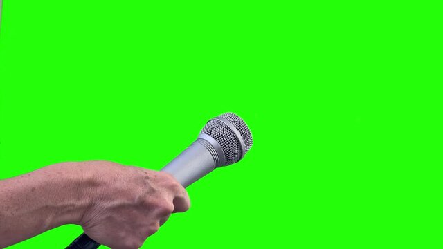 Mic Isolated on Green Screen,  Microphone Cut Out on Green Chroma Background. Close Up. You can replace green screen with the footage or picture you want with “Keying” effect in After Effects. 4K.