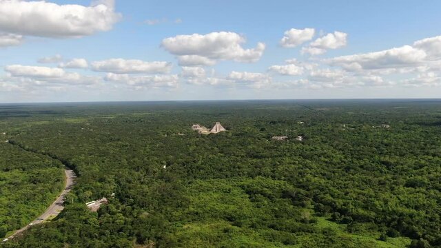 4K Aerial View of Chichen Itza, Temples Complex of Ancient hidden Mayan City in Mexican Rainforest, Drone Shot. Famous Kukulkan Pyramid in the middle of nature. Yucatan, Mexico. Pyramid El Castillo.