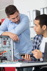 apprentice repairing computer in technical school