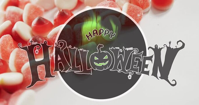 Happy halloween text banner against close up of candy corns on white surface