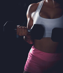 Cross training. Young woman exercising at the gym