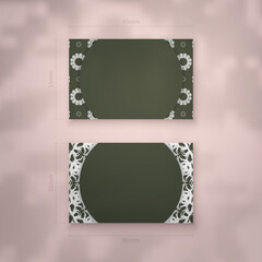 Presentable business card in dark green color with antique white ornaments for your personality.
