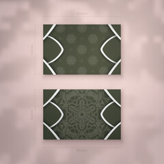 Presentable business card in dark green color with Greek white pattern for your business.