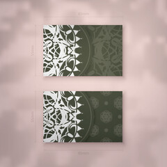 Presentable business card in dark green color with luxurious white ornaments for your personality.