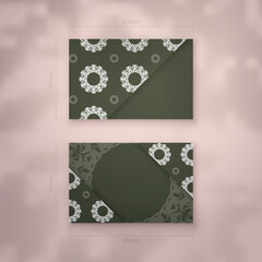 Presentable business card in dark green color with mandala white ornament for your personality.