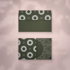 Presentable business card of dark green color with mandala white ornament for your brand.