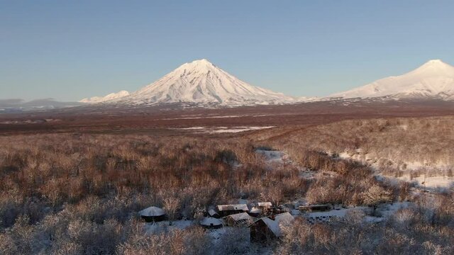 4K Aerial footage of three famous volcanoes in Kamchatka, Russia. Cones of Koryaksky volcano, Avachinsky volcano and Kozelskiy volcano. Kamchatka nature in winter.
