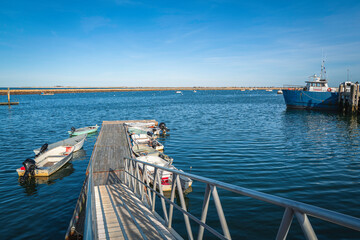 Boat ramp, dinghies, and fishing trawlers in Plymouth Harbor, Massachusetts.