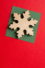 isolated wooden snowflake on paper