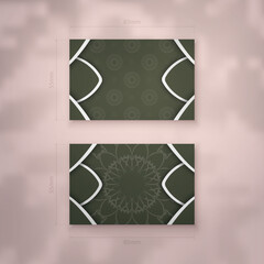 Visiting business card template in dark green color with mandala white pattern for your business.