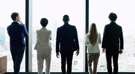 Multinational people looking out from the office. Global business.