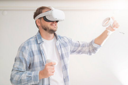 man wearing Virtual Reality VR Headset. VR for gaming. Man play game in VR glasses.